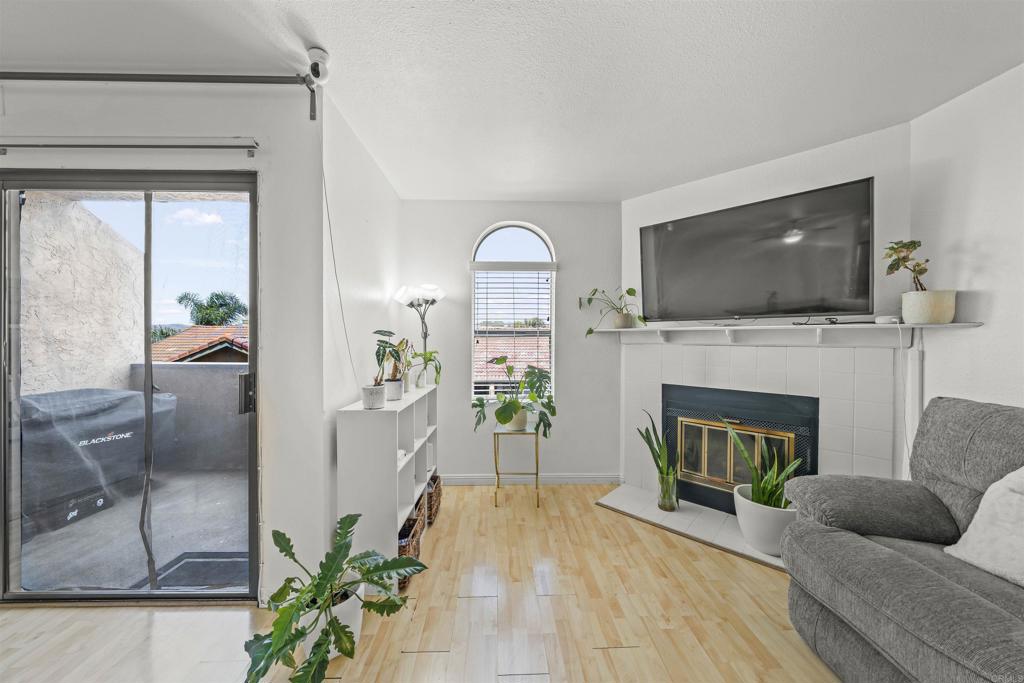 10775 Tamar Terrace, Unit A Santee, CA 92071 - Photo 8 of 38 a living room with furniture a fireplace and a flat screen tv