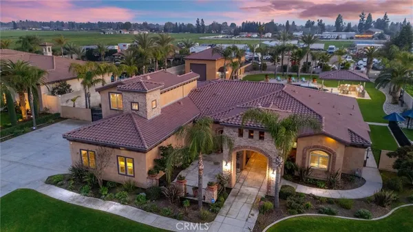 an aerial view of a house with a garden and mountain view in back