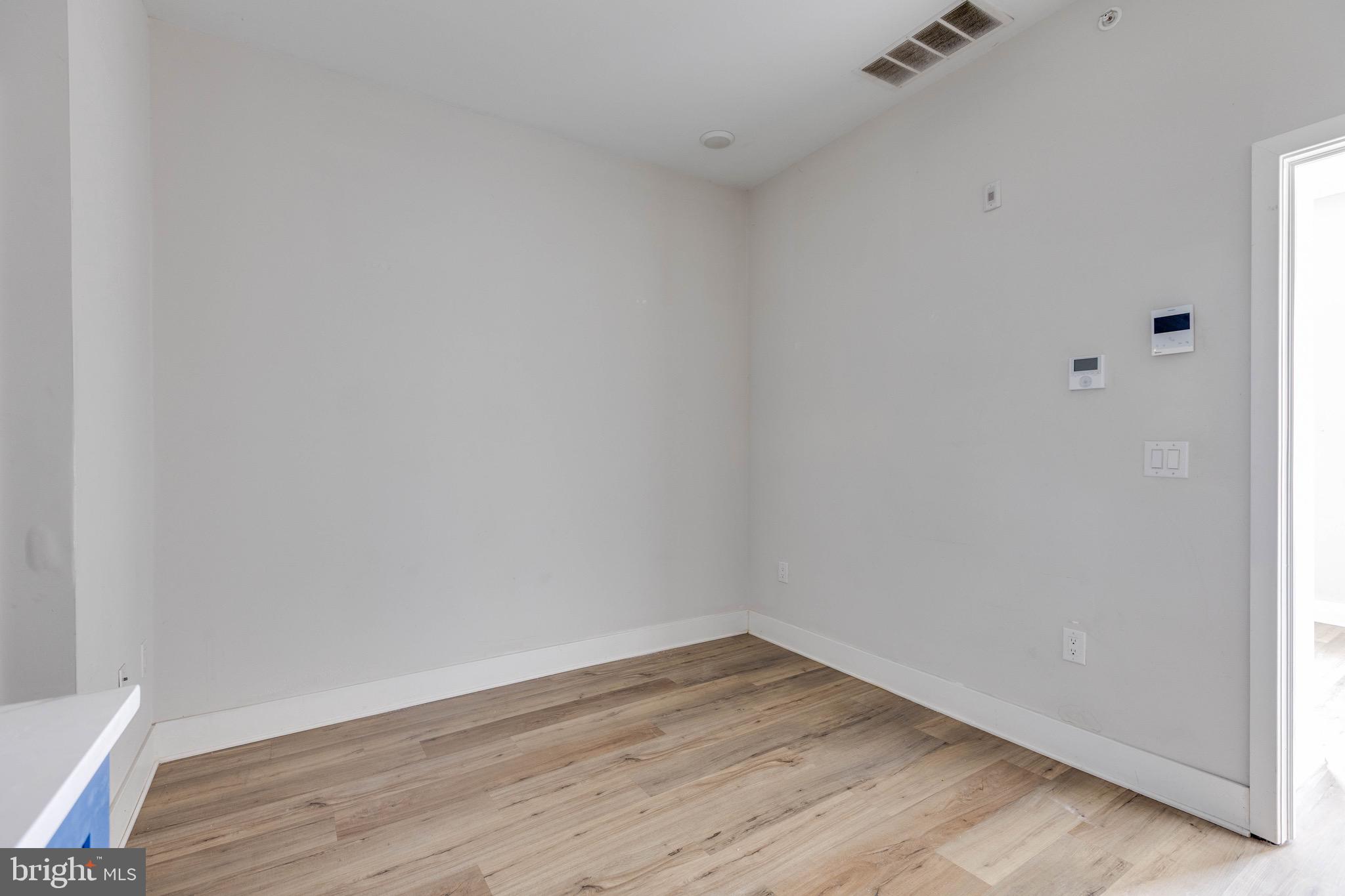 1535 North 6th Street, Unit E Philadelphia, PA 19122 - Photo 8 of 11 a view of an empty room with wooden floor