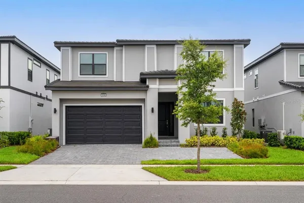 a front view of a house with a yard and garage