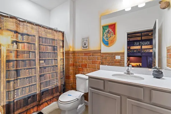 a bedroom with a bed and a painting on the wall