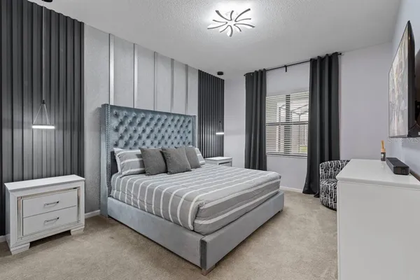 a bedroom with a bed and the painting on the wall