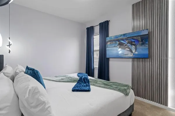 a bedroom with a large bed and a window