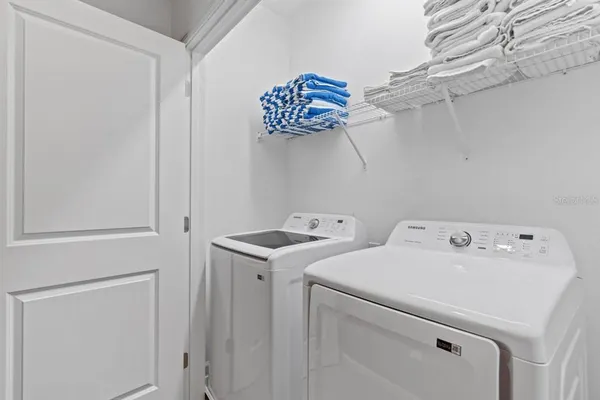 a view of a dining room with furniture wooden floor and a potted plant