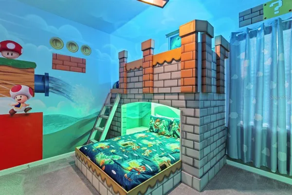 a kitchen with stainless steel appliances a table chairs refrigerator and microwave