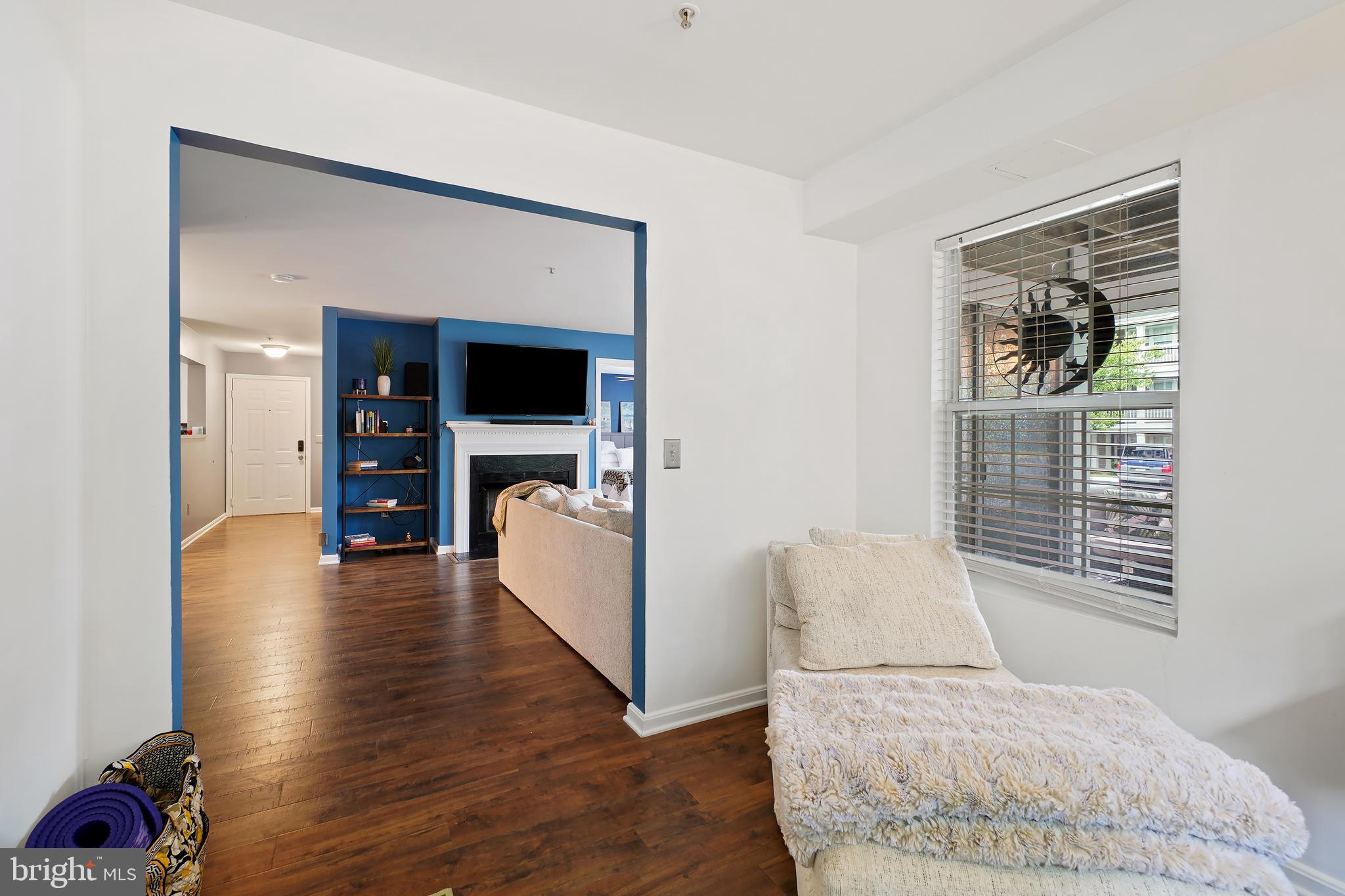 14151 Cuddy Loop, Unit 101 Woodbridge, VA 22193 - Photo 11 of 45 a living room with furniture and a fireplace