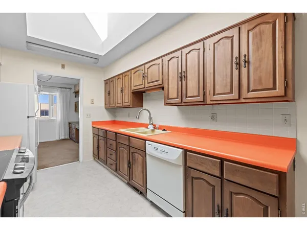 a kitchen with stainless steel appliances granite countertop a sink and cabinets