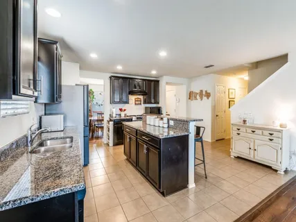 a kitchen with stainless steel appliances granite countertop a stove and a sink