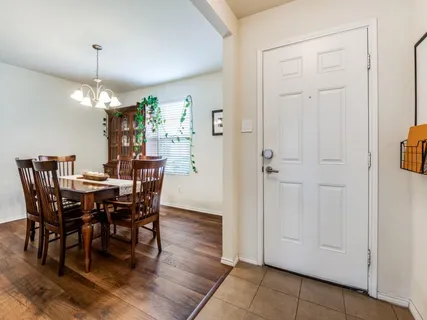 a view of a dining room with furniture wooden floor and chandelier