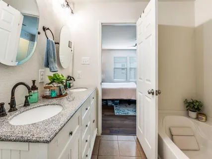 a bathroom with a granite countertop sink mirror and toilet