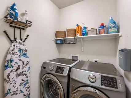 a living room with furniture a window and a flat screen tv
