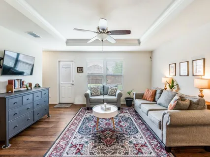 a living room with furniture and a rug