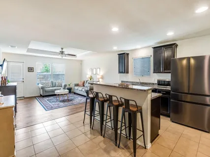a kitchen with a stove a sink and a refrigerator