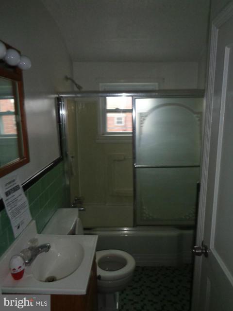 336 Stemmers Run Road Baltimore, MD 21221 - Photo 8 of 13 a bathroom with a toilet and a shower