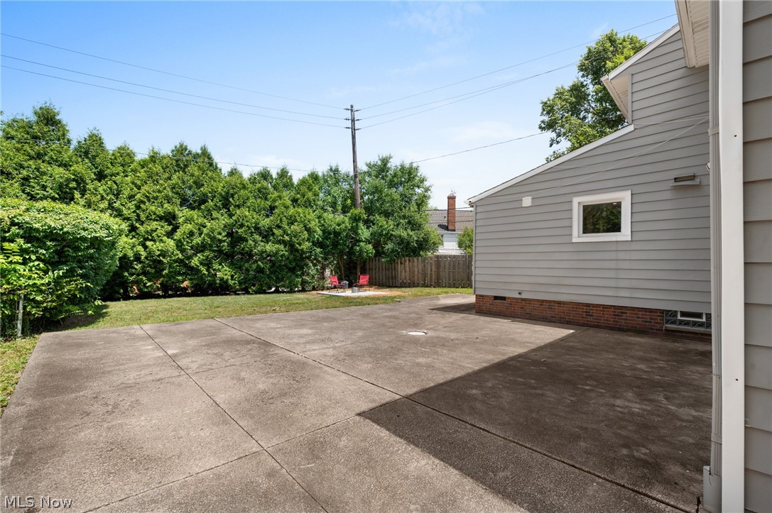 22625 Rye Road Shaker Heights, OH 44122 - Photo 35 of 38 Spacious concrete patio and lawn area with mature evergreen landscaping providing natural screening