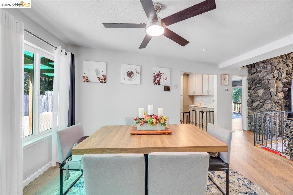 8733 Fraguero Road Sonora, CA 95370 - Photo 36 of 73 Dining area featuring wood-finish flooring, a contemporary ceiling fan, and a large window