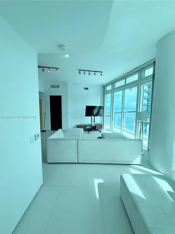 a bathroom with a granite countertop sink a mirror and bathtub