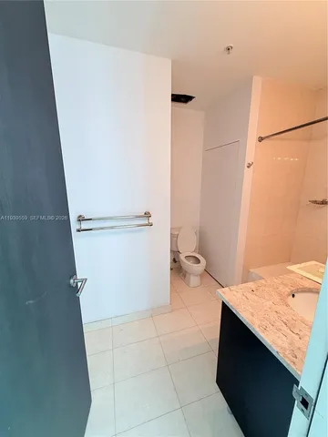 a bathroom with a shower toilet and sink