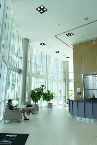 a living room with furniture and large windows