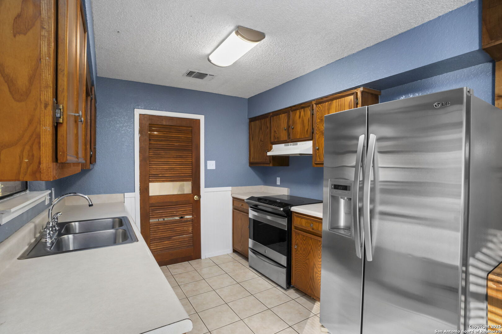 127 Harless Way Center Point, TX 78010 - Photo 11 of 25 a kitchen with stainless steel appliances granite countertop a refrigerator and a stove