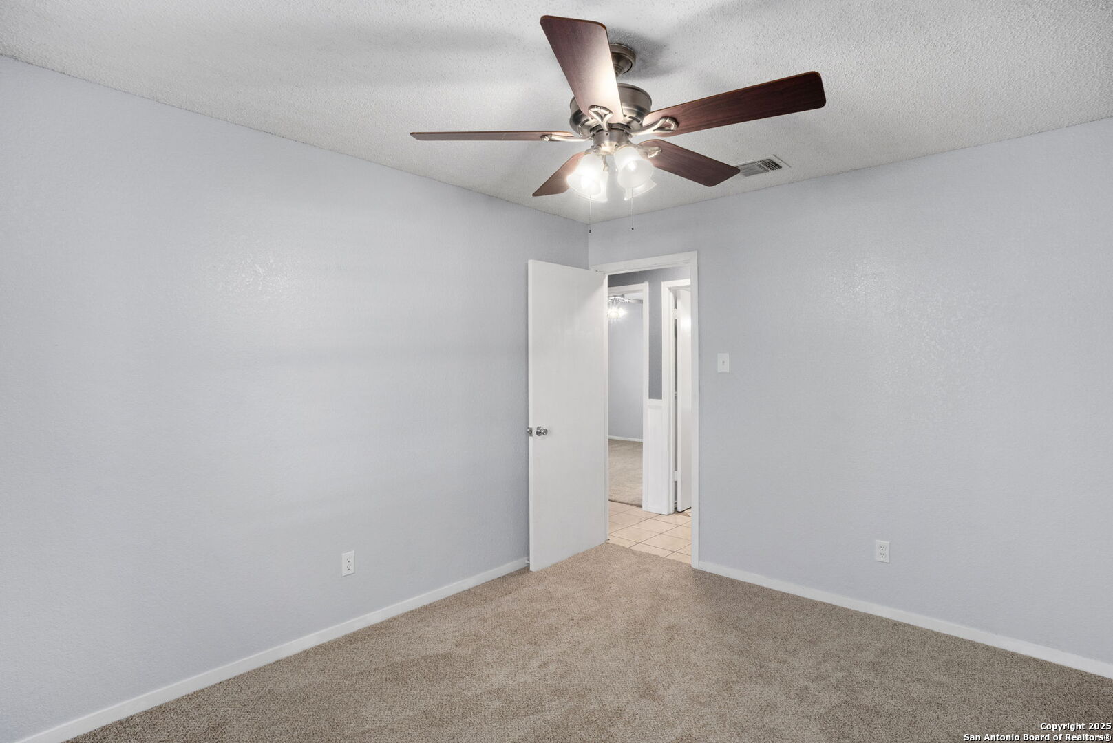 127 Harless Way Center Point, TX 78010 - Photo 18 of 25 an empty room with a window and a fan