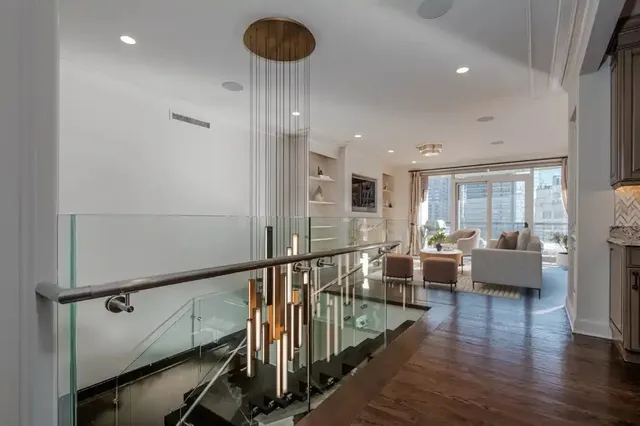 a view of a living room and dining room with wooden floor