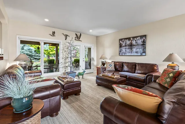 a living room with furniture and large windows