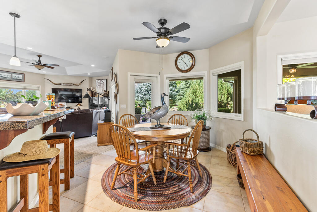 15103 6260th Road Montrose, CO 81403 - Photo 17 of 54 a dining room with furniture a clock and a large window