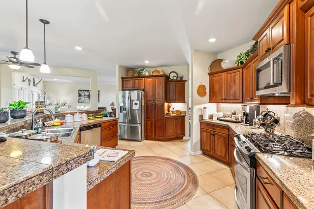 a living room with furniture a flat screen tv and a large window