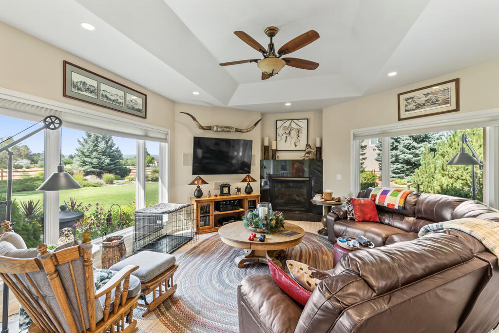 15103 6260th Road Montrose, CO 81403 - Photo 21 of 54 a living room with furniture a flat screen tv and a large window