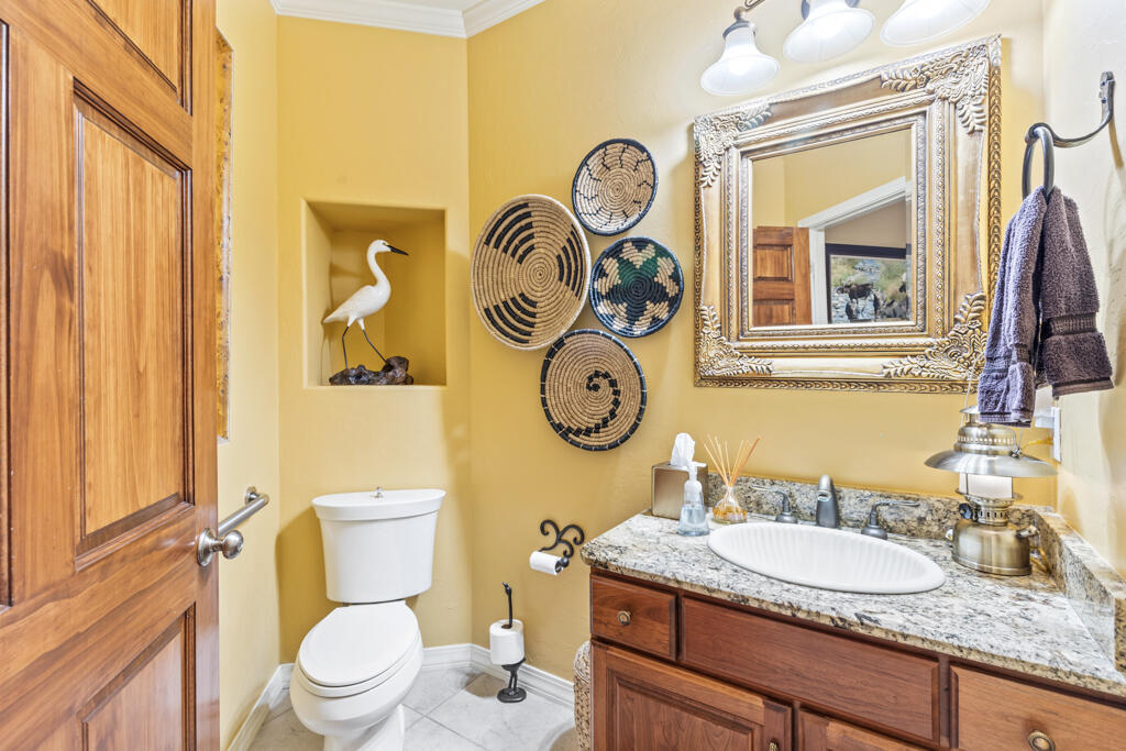15103 6260th Road Montrose, CO 81403 - Photo 35 of 54 a bathroom with a granite countertop toilet sink and mirror