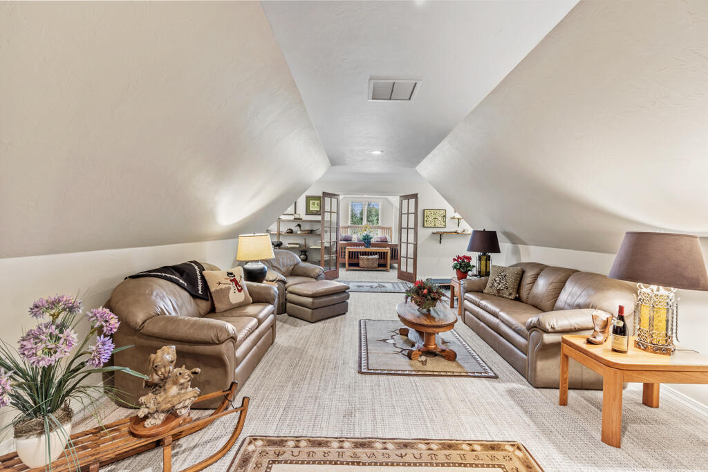 15103 6260th Road Montrose, CO 81403 - Photo 36 of 54 a living room with furniture a rug and a chandelier