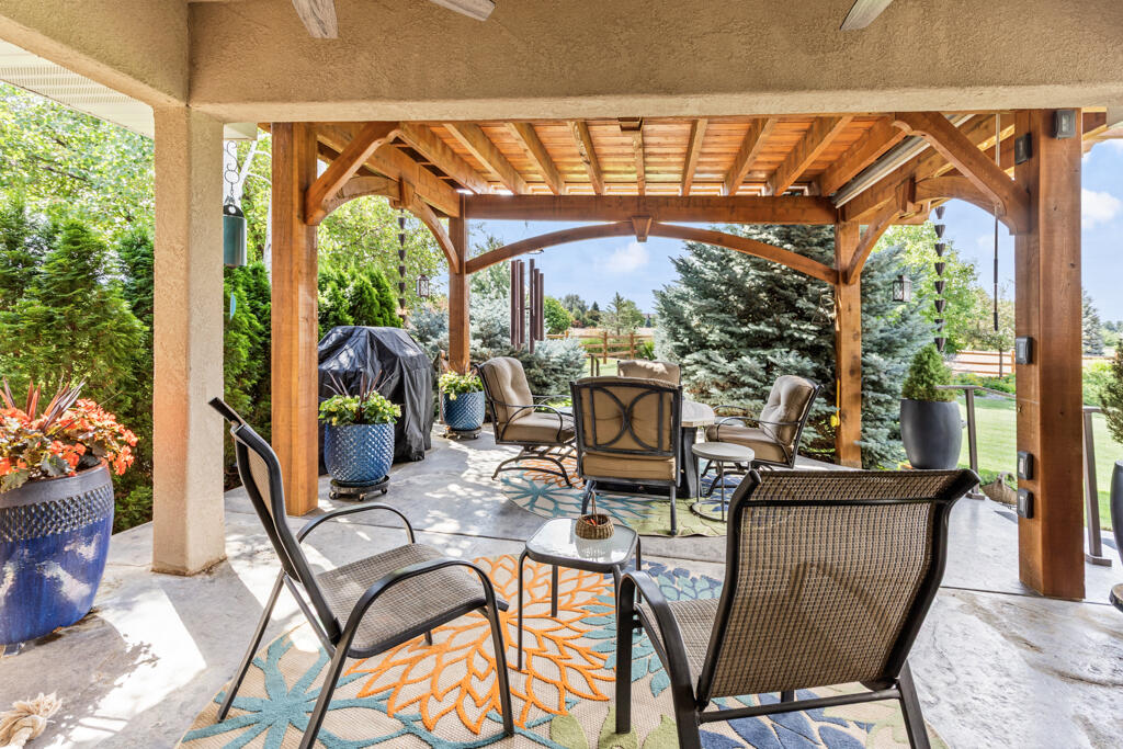 15103 6260th Road Montrose, CO 81403 - Photo 40 of 54 a view of a patio with table and chairs potted plants with wooden floor and outdoor view