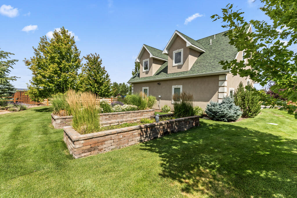15103 6260th Road Montrose, CO 81403 - Photo 47 of 54 a front view of a house with a yard