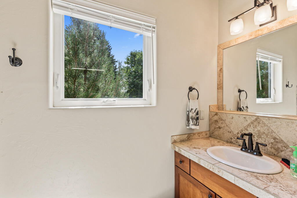 15103 6260th Road Montrose, CO 81403 - Photo 49 of 54 a bathroom with a granite countertop sink and a mirror