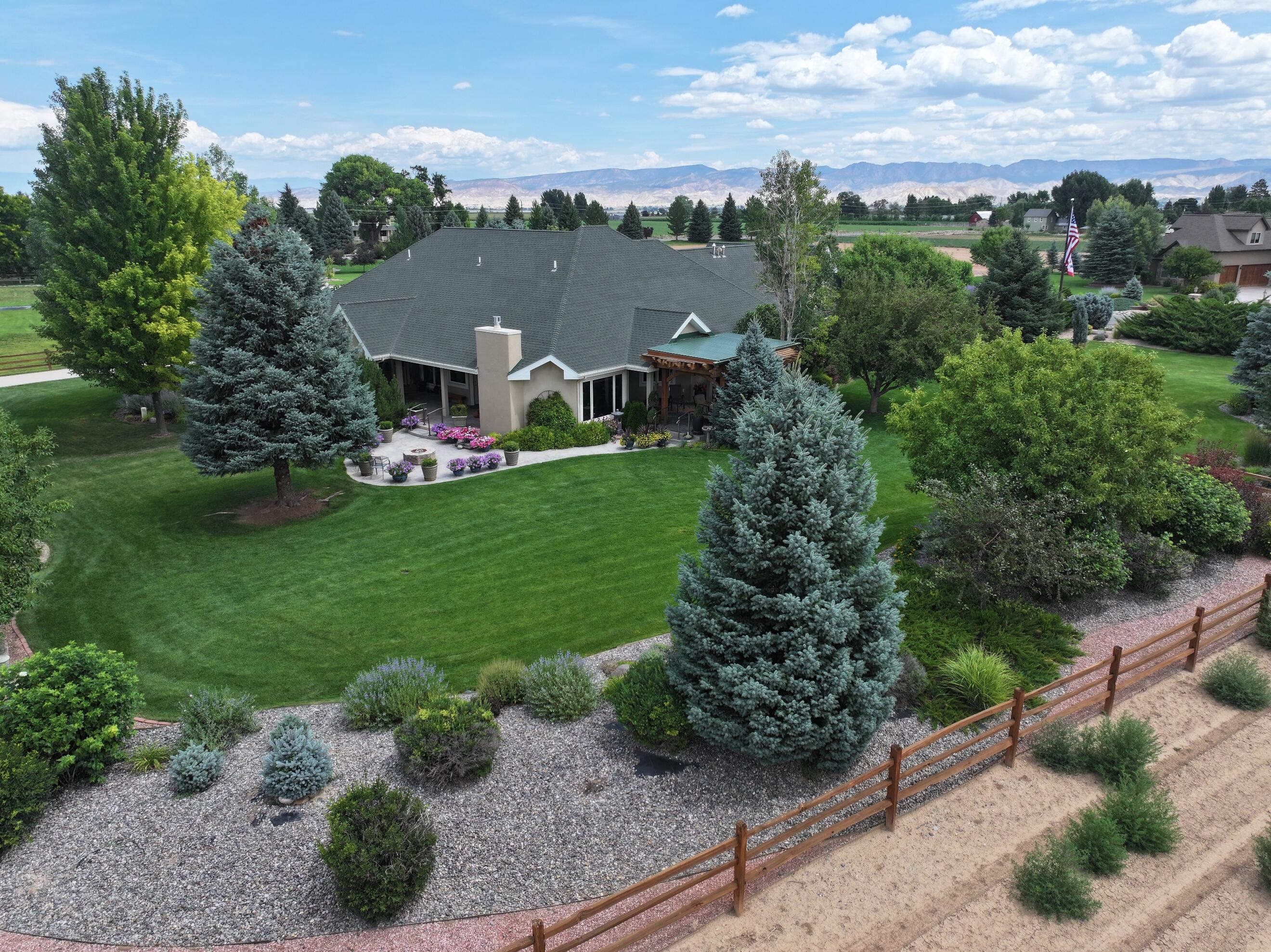 15103 6260th Road Montrose, CO 81403 - Photo 7 of 54 a view of a garden with a house in the background