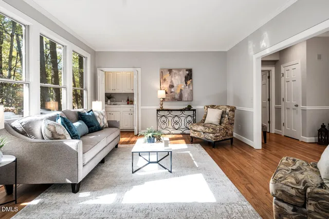 a living room with furniture and wooden floor