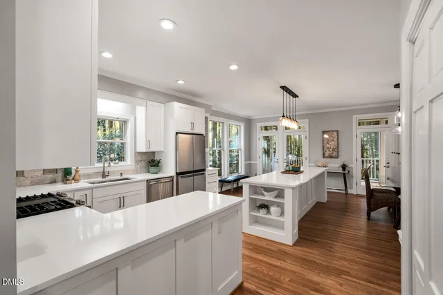 a kitchen with a sink stove and cabinets