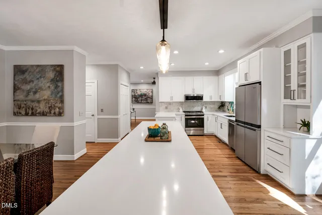 a dining room with furniture wooden floor and a chandelier
