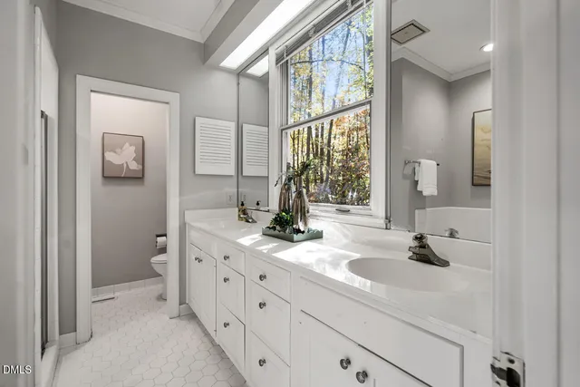 a white toilet sitting next to a bathroom sink