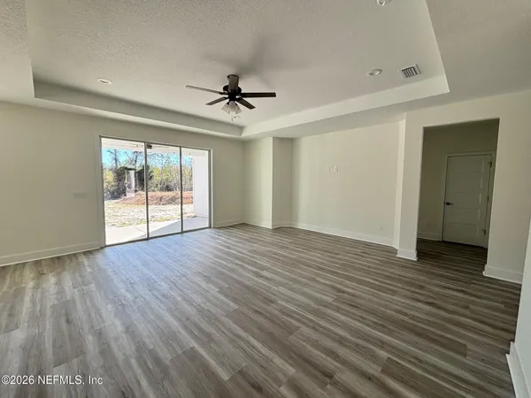 a kitchen with stainless steel appliances granite countertop a sink a stove and a wooden floors