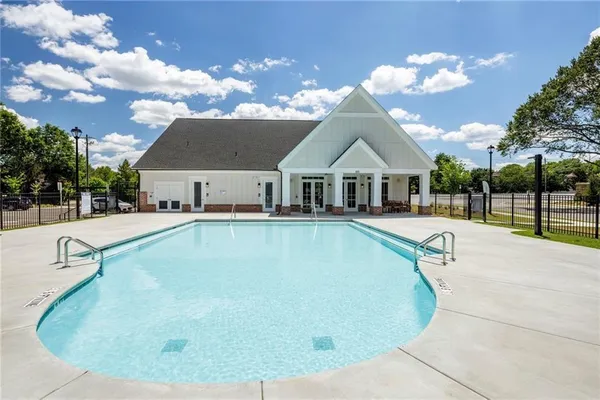 a view of a house with swimming pool and sitting area