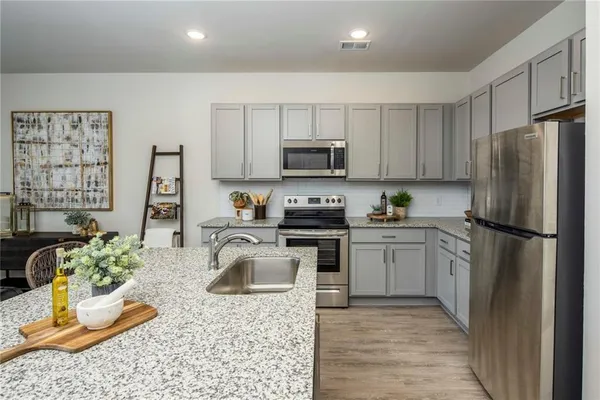 a kitchen with a refrigerator sink and stove