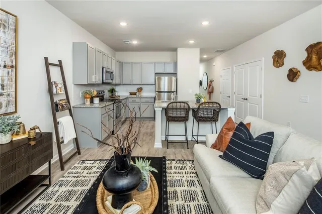 a living room with furniture a rug and a chandelier