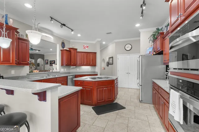 a kitchen with stainless steel appliances granite countertop a stove and a sink