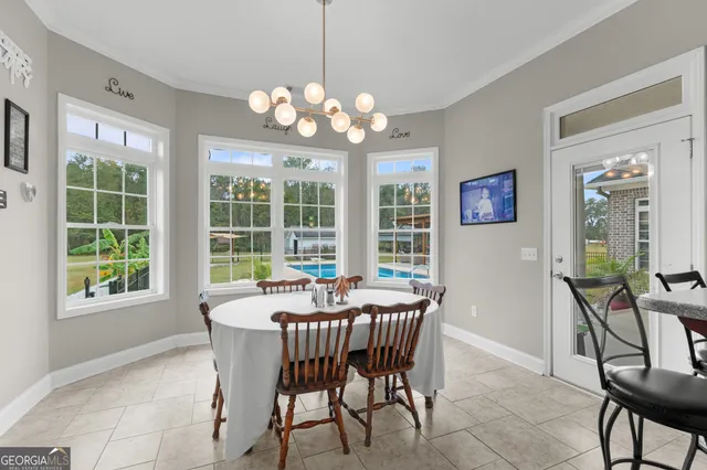 a dining room with furniture a chandelier and a rug