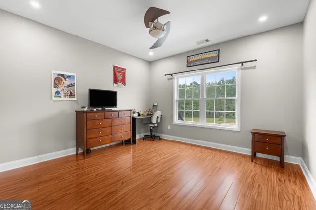a view of empty room with wooden floor