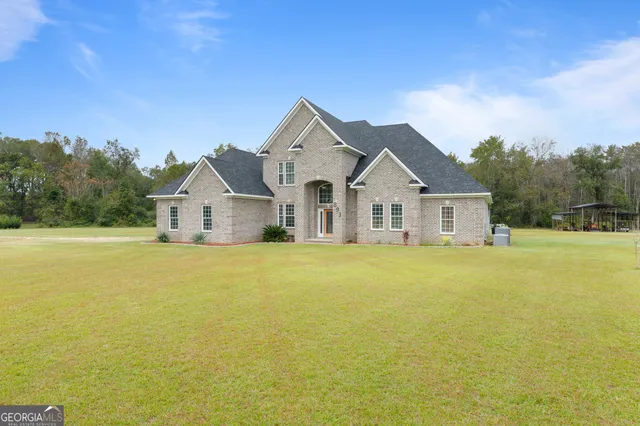 a view of a house with a yard and garage