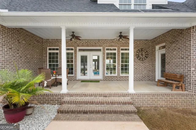 a view of a patio with a table and chairs