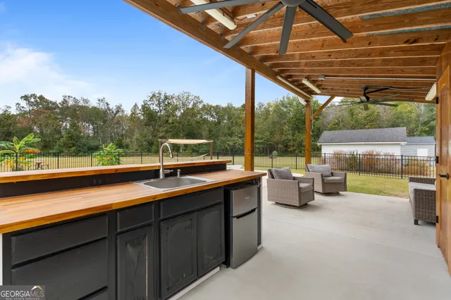 a view of a big house with a big yard and large trees